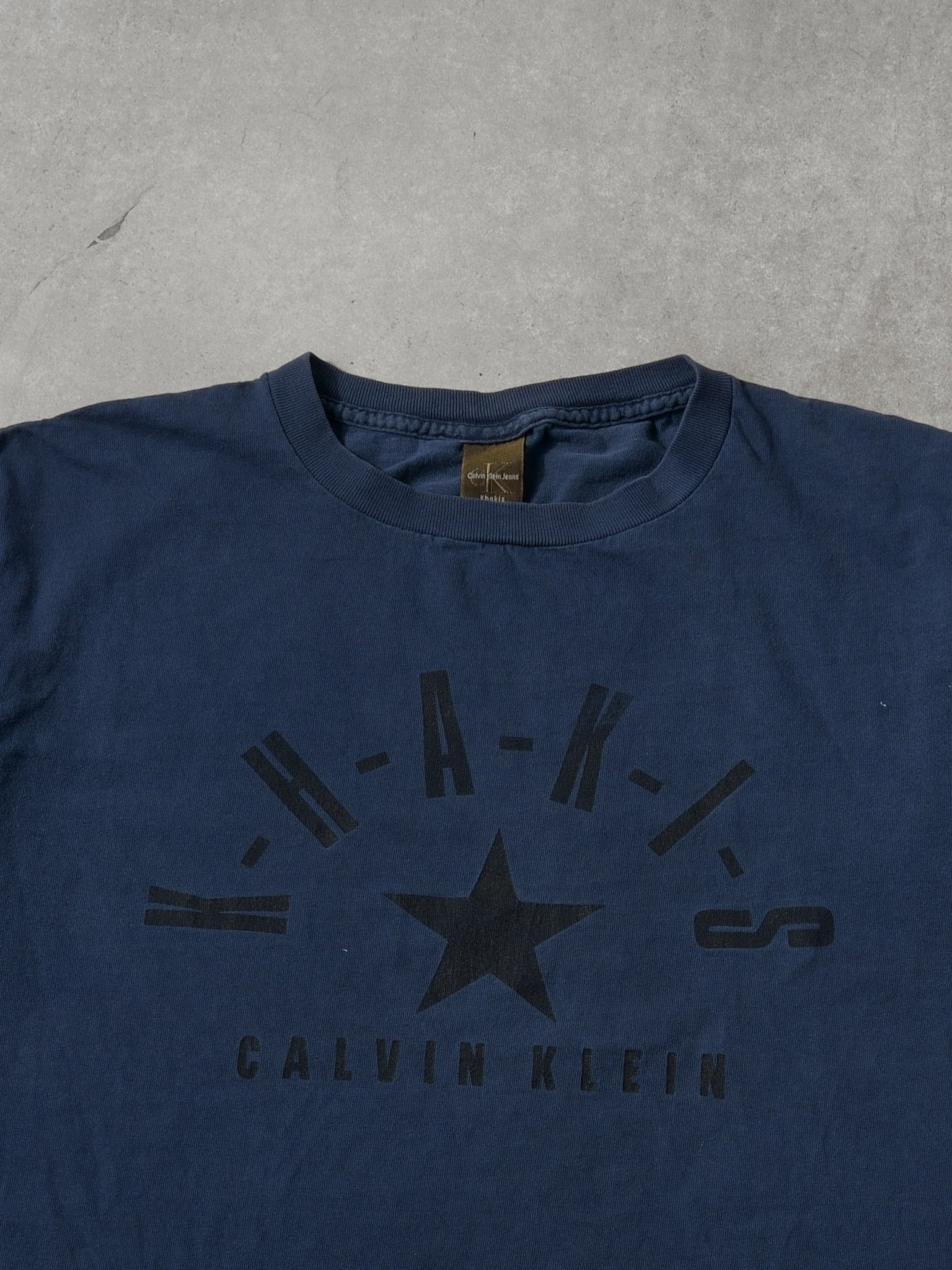 Vintage 90s Navy Blue Calvin Klein Khakis Jeans Graphic Tee (M) - Image 2
